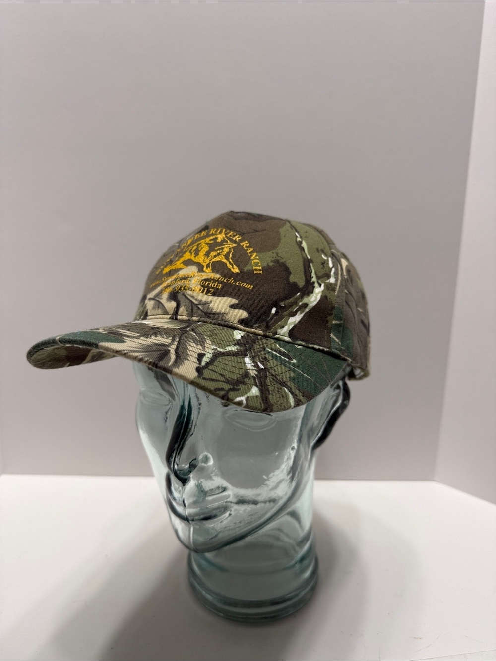 NISSIN Suwannee River Ranch Olive Green Camo Cap with Red & Blue Logo Tag